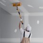 worker using VEVOR drywall flat box handle on ceiling, wearing white gloves, cap, and protective apron.