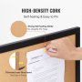 hand pinning a document on a high-density VEVOR cork board with a black frame; self-healing, easy to pin.