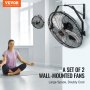 VEVOR wall mount fan set of 2 in a spacious room with a person meditating, offering powerful cooling.