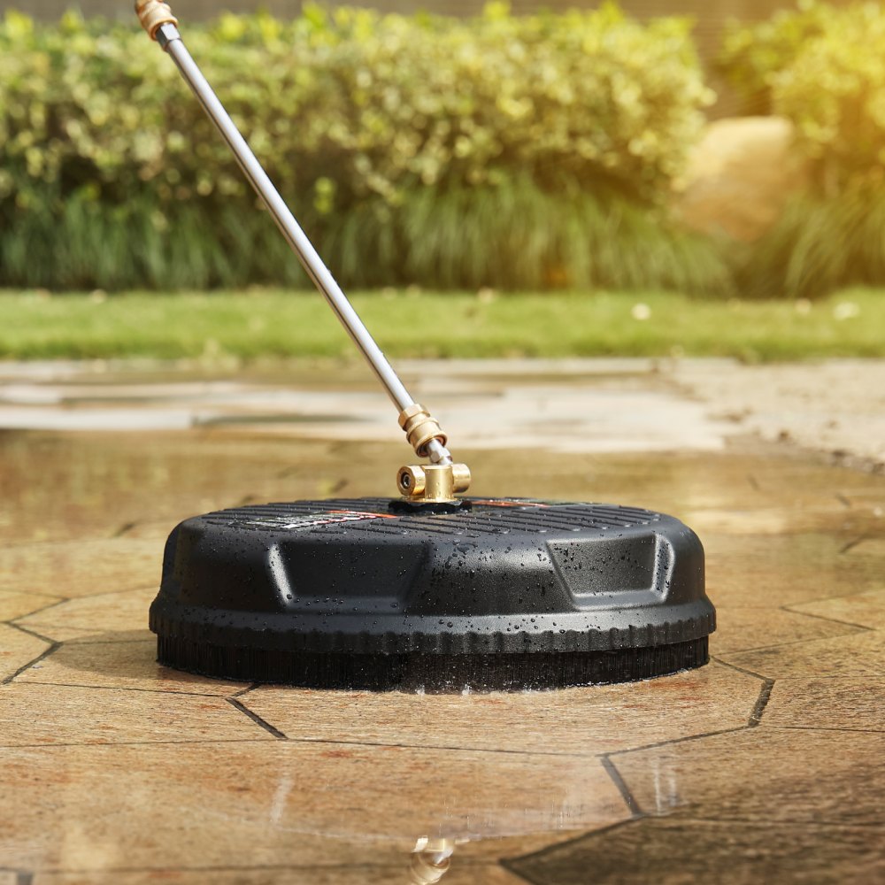 VEVOR pressure washer surface cleaner cleaning patio tiles with green garden in the background.