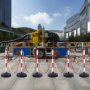 VEVOR traffic delineator post set with red and white striped posts, chains, and industrial background.
