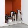 VEVOR pull out cabinet organizer with kitchenware items in stainless steel rack against orange background.