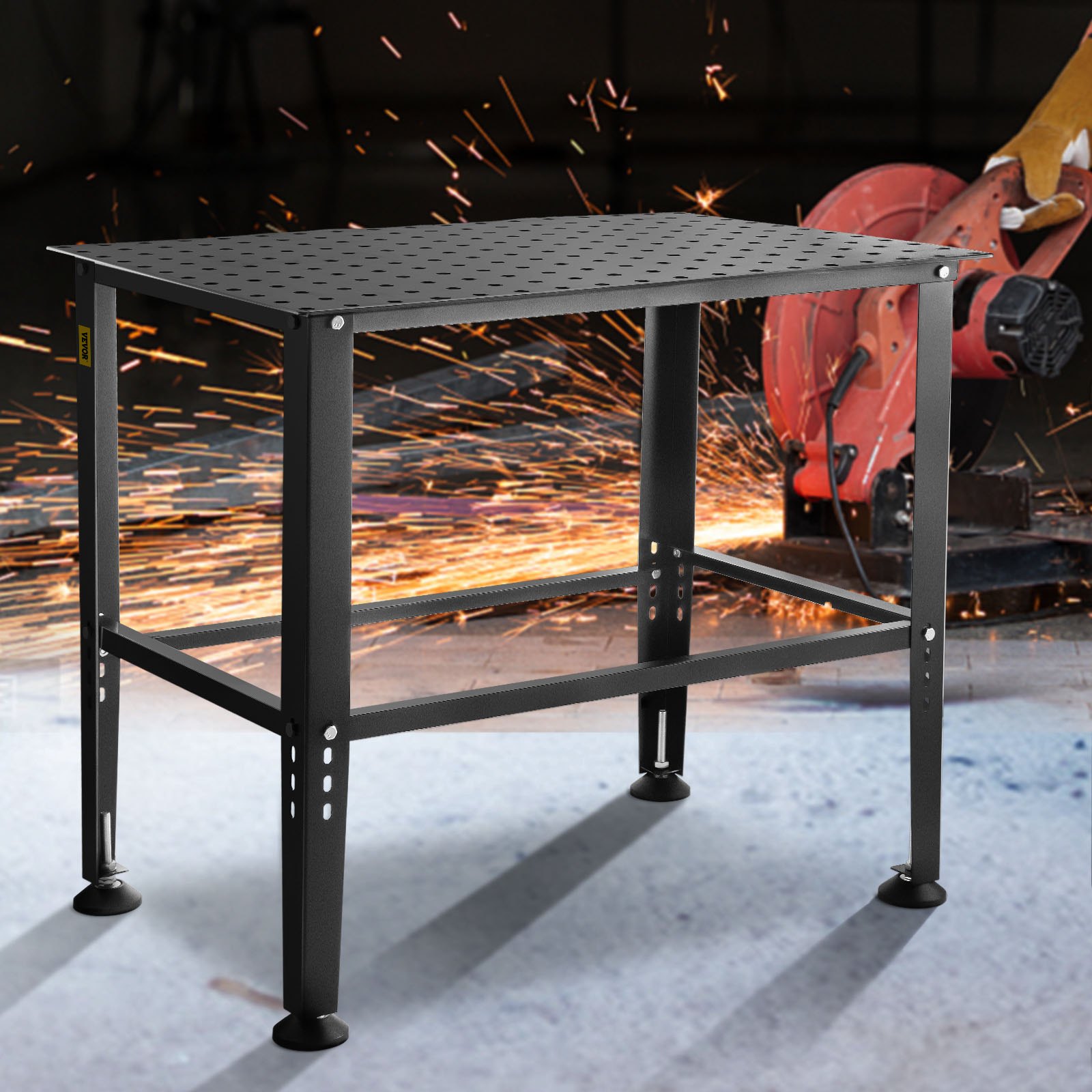 VEVOR welding table with sparks flying from an angle grinder in the background.