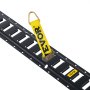 yellow VEVOR e track strap with hook attached to black e track rail, showcasing tie-down functionality.