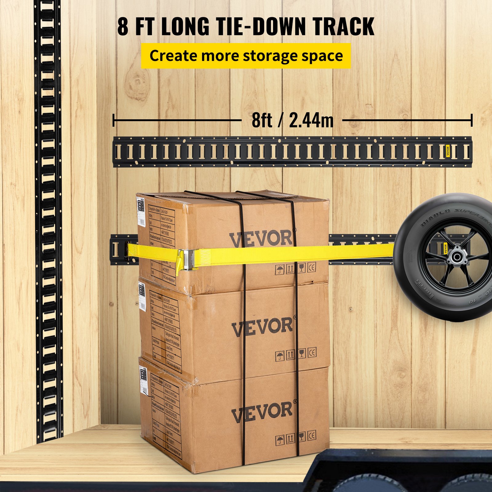 VEVOR e-track tie-down rail secures stacked boxes and a tire in a wooden cargo area.