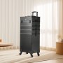 black VEVOR makeup train case with wheels and handle, standing in a bright room with beige curtains.