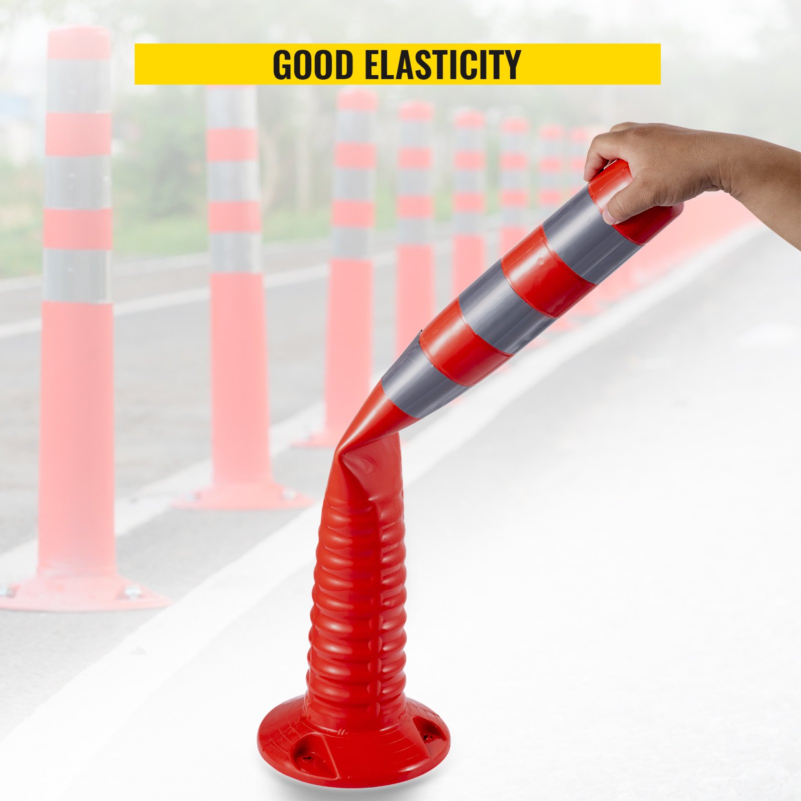 VEVOR traffic delineator cones showing flexibility and durability on a road.