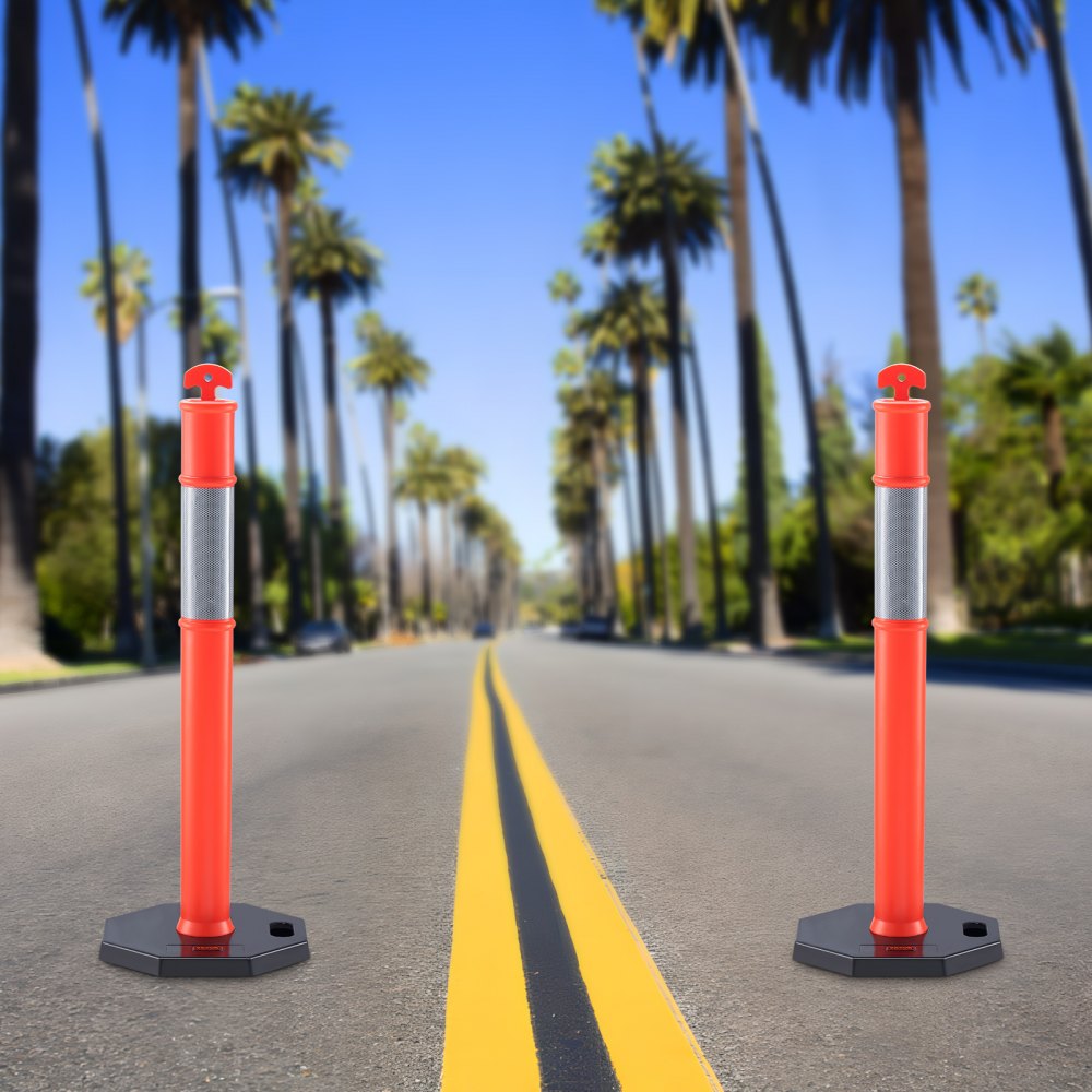 two VEVOR traffic delineators on an empty palm tree-lined road with a bright blue sky.