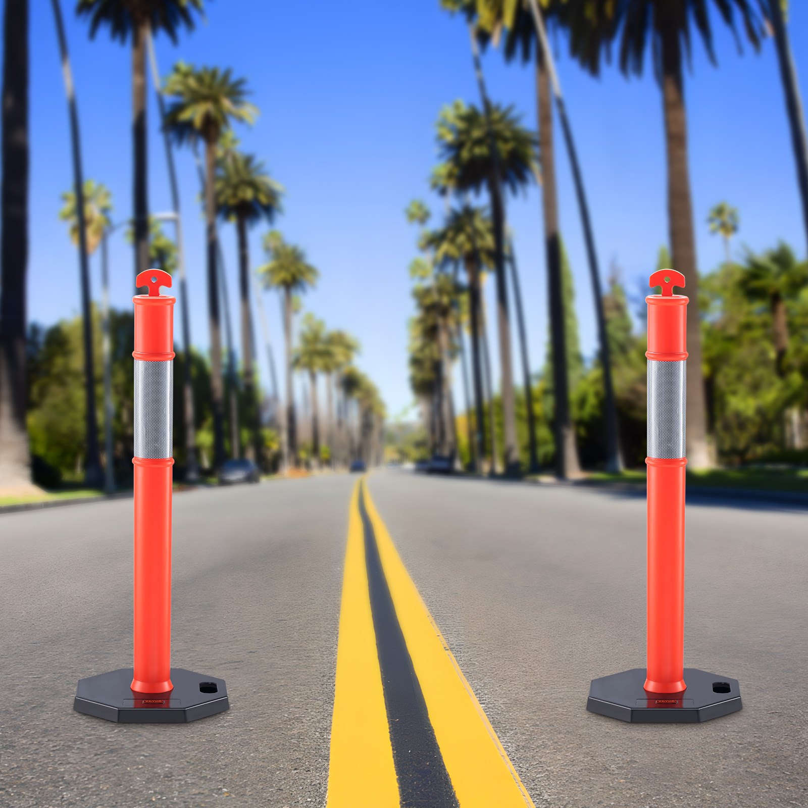 two VEVOR traffic delineators on an empty palm tree-lined road with a bright blue sky.