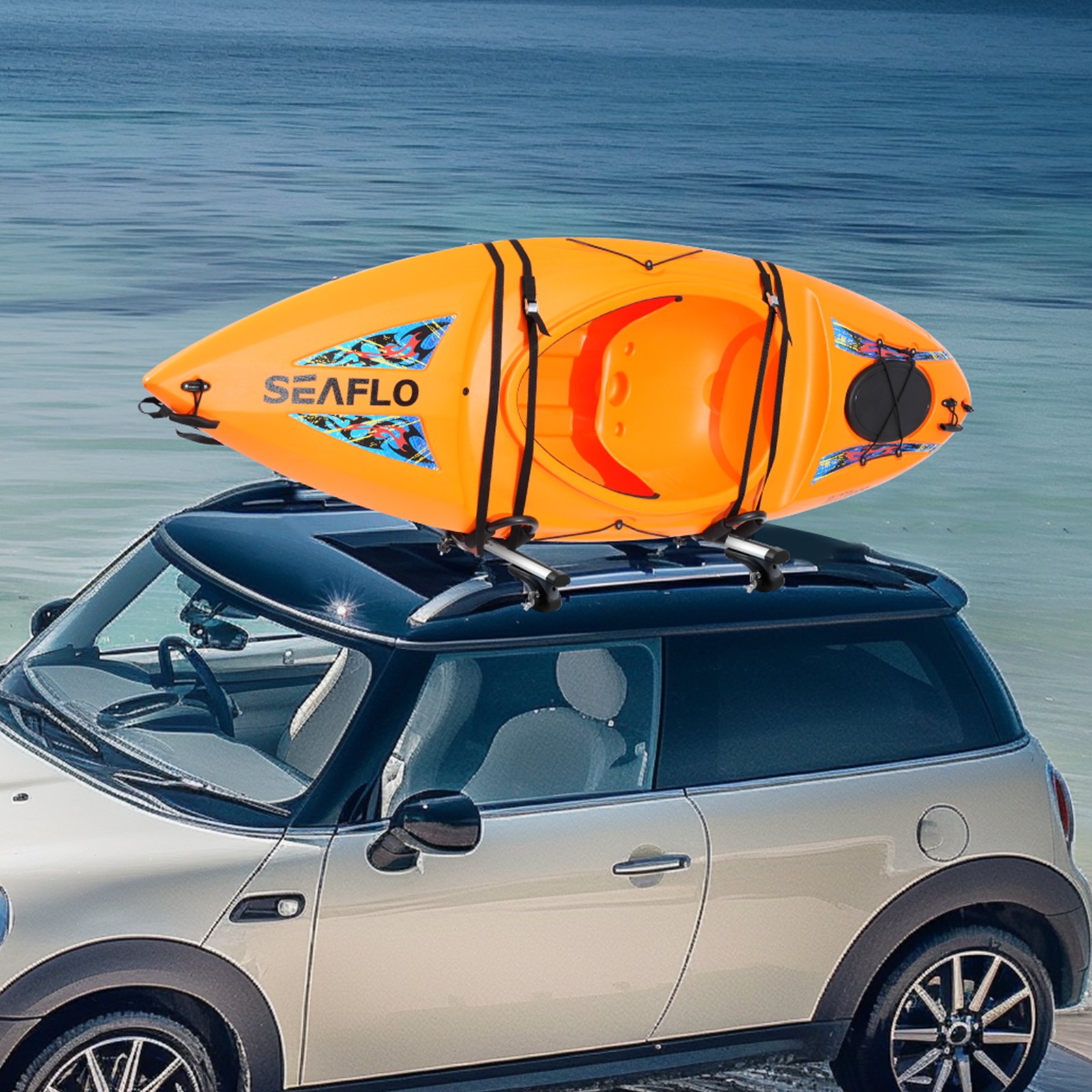 orange kayak secured on a black mini cooper with a VEVOR kayak roof rack by the calm blue sea.