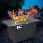 outdoor gathering around VEVOR gas fire pit table with friends raising glasses at sunset.