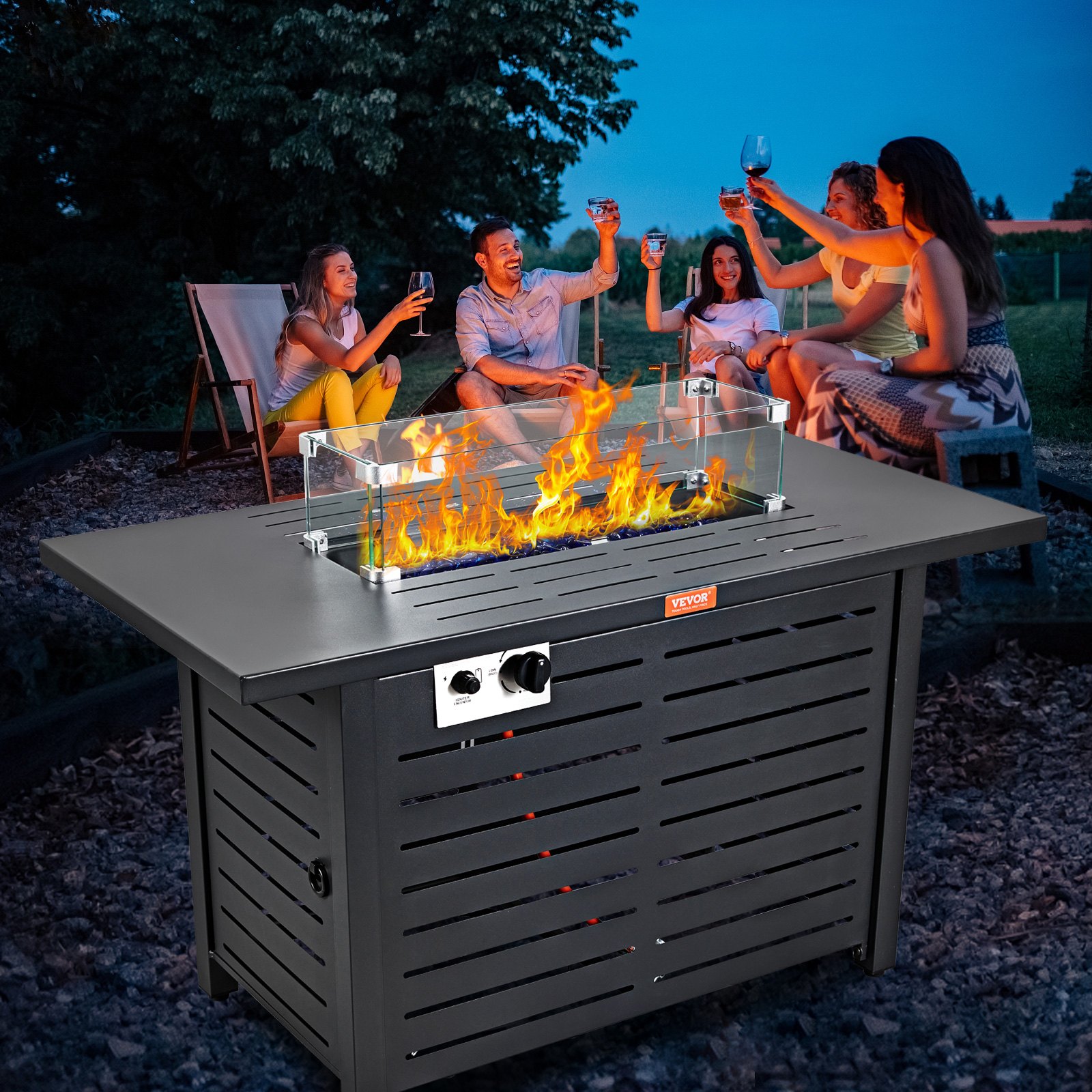 outdoor gathering around VEVOR gas fire pit table with friends raising glasses at sunset.