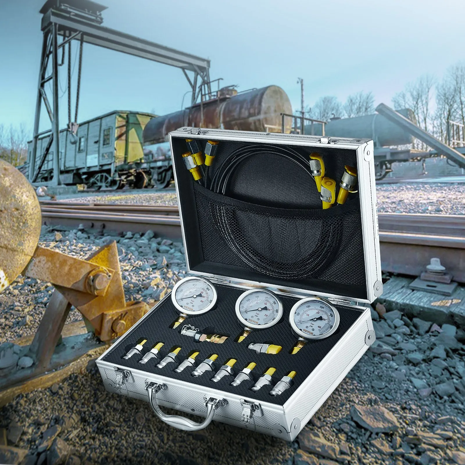 VEVOR hydraulic pressure test kit in an open case by a railway track with gauges and connectors displayed.