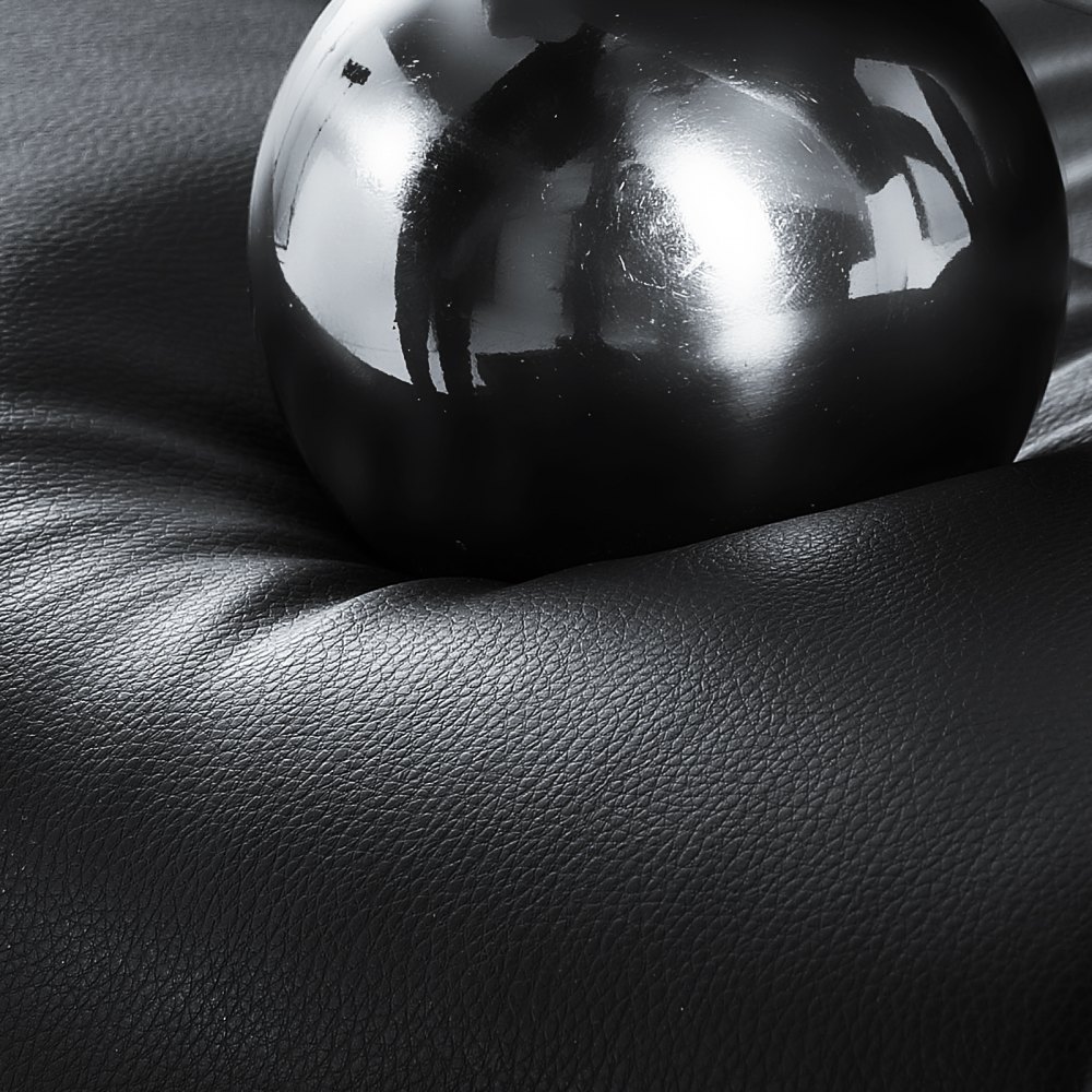 black ball on textured cushion of VEVOR executive office chair in close-up view.