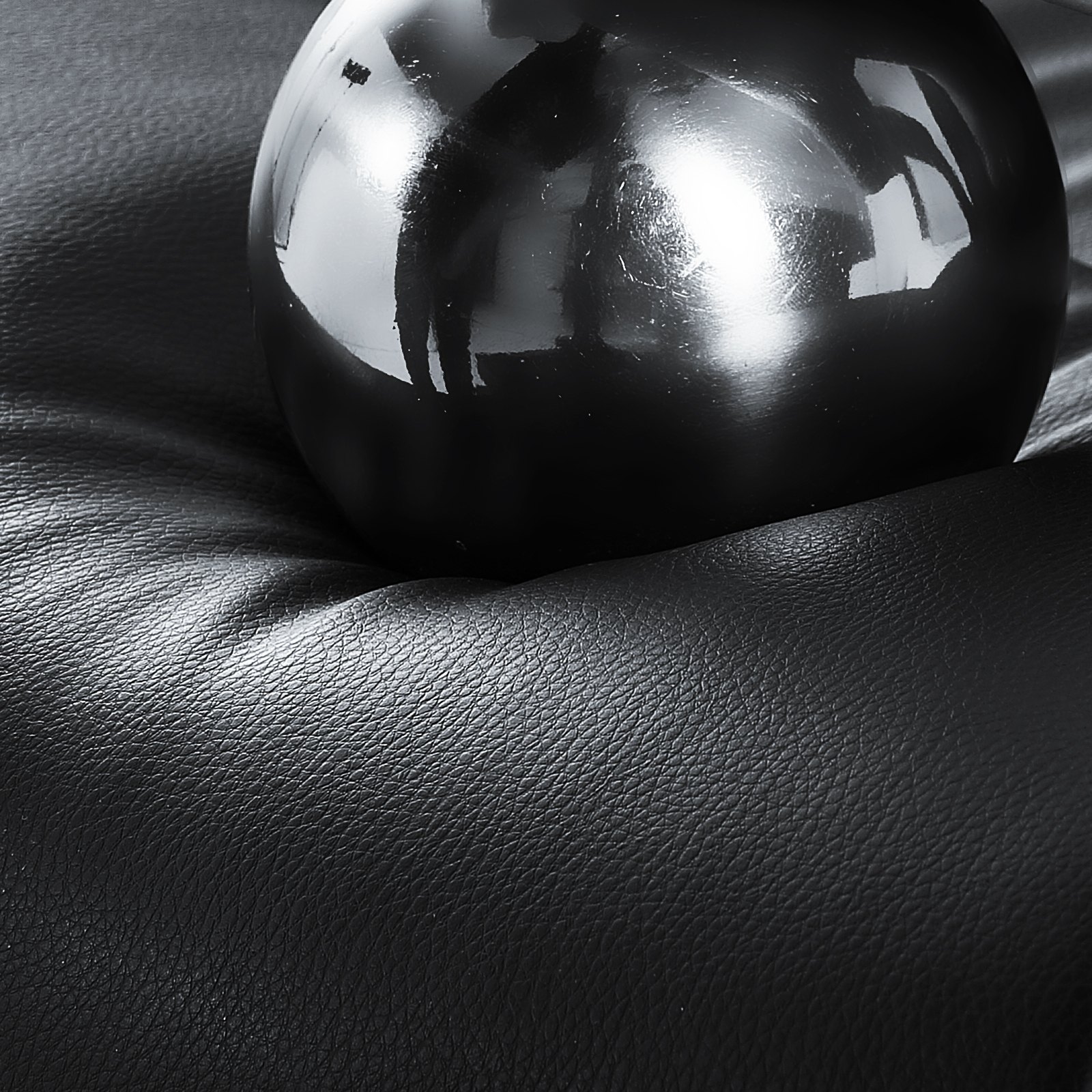 black ball on textured cushion of VEVOR executive office chair in close-up view.