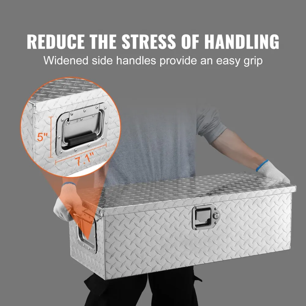 man carrying VEVOR aluminum truck bed tool box with wide side handles for easy grip.