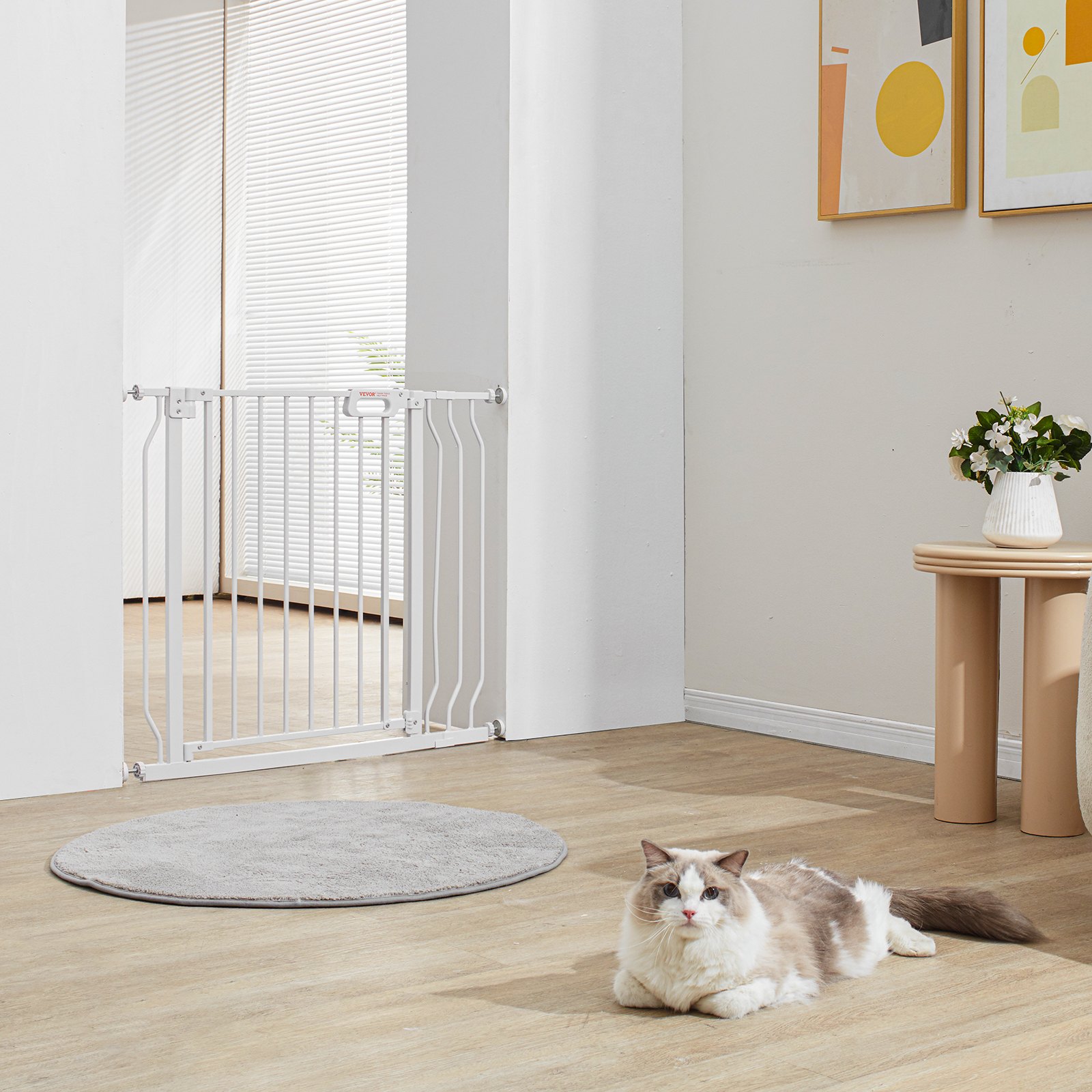 VEVOR baby gate in a modern living room with a cat lying on wooden floor next to a table and artwork.