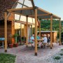 backyard gathering under a wooden pergola featuring the VEVOR pergola bracket kit, with patio string lights.