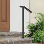 black VEVOR steel railing on stone steps beside a wooden door and green plants.