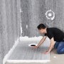installing VEVOR shower pan kit in progress, technician fitting drain on tiled shower floor in bathroom.
