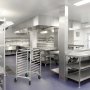 commercial kitchen with stainless steel surfaces and a VEVOR bun pan rack in the center.