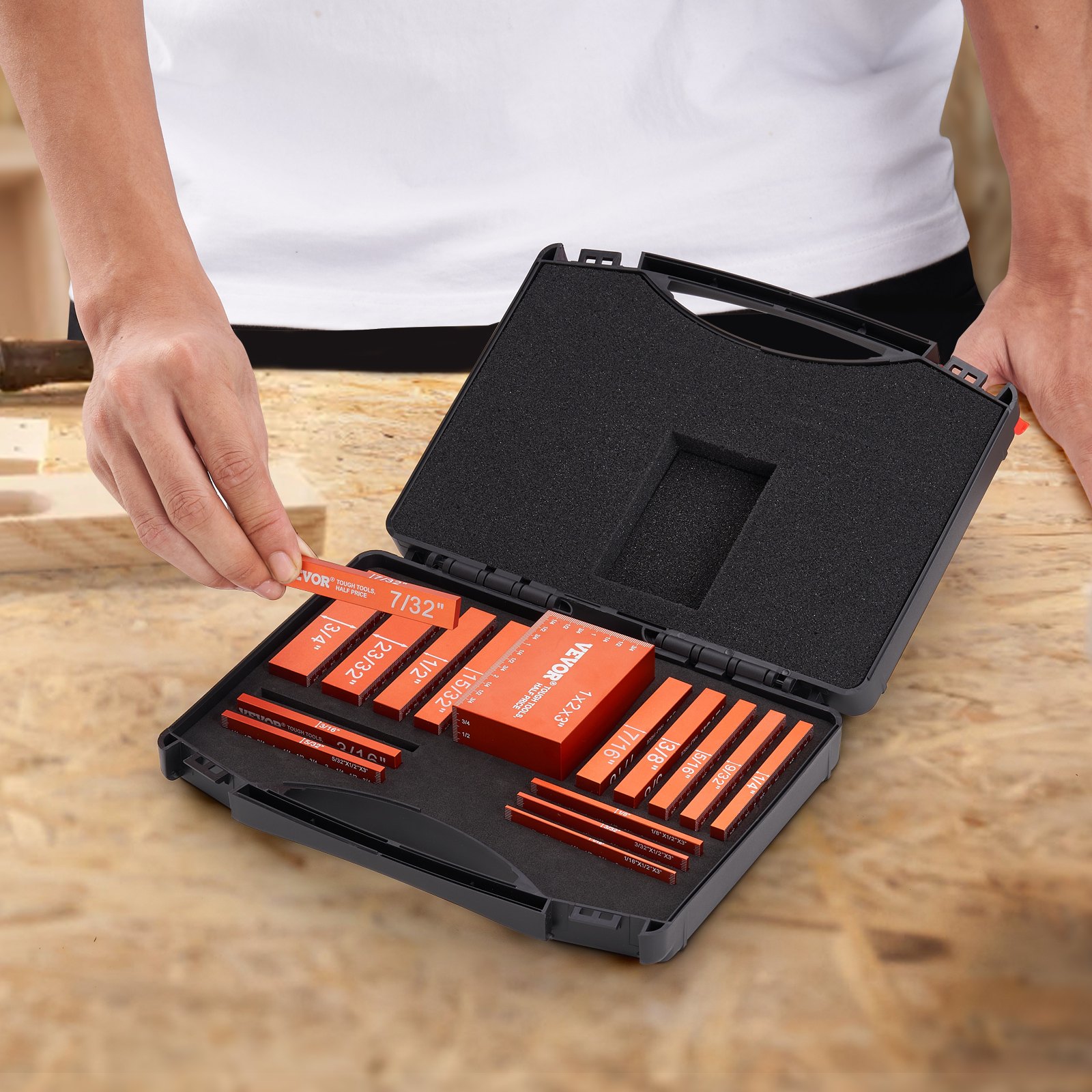person handling VEVOR woodworking tools in a black case on a wooden workbench.