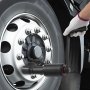 hand using VEVOR torque multiplier on vehicle wheel lug nuts, wearing white glove.