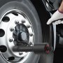 mechanic using VEVOR torque multiplier on a large truck wheel.