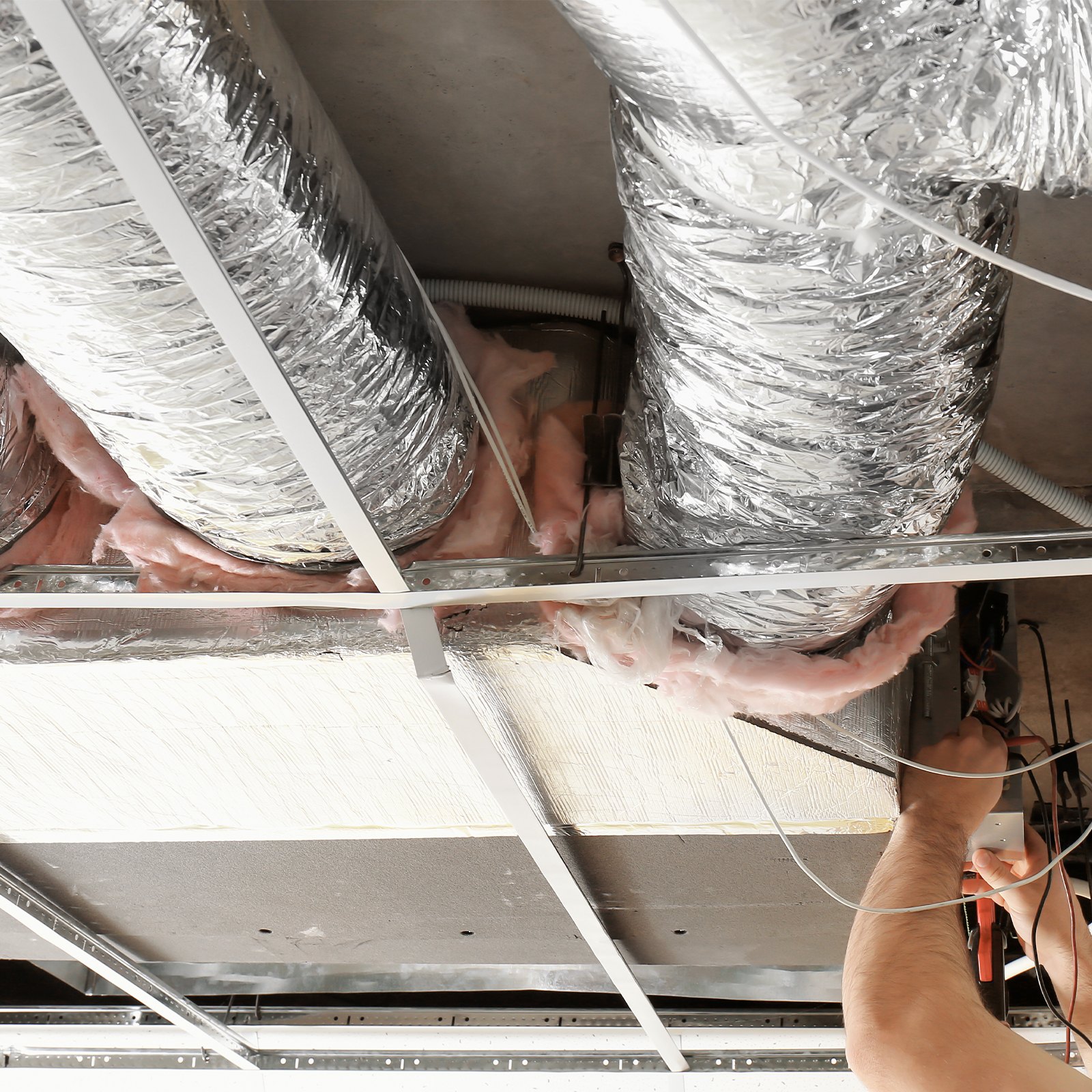 installing VEVOR dryer vent hose in ceiling, surrounded by insulation and support beams.