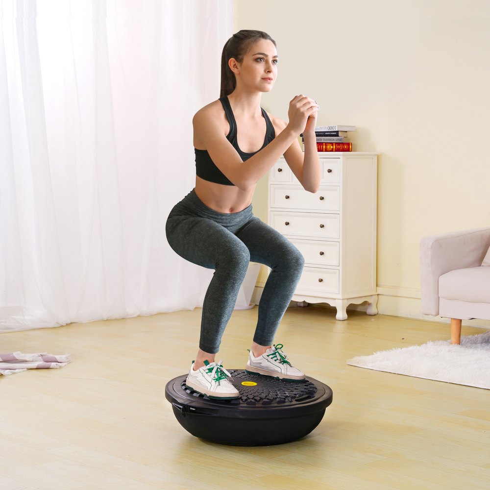 woman exercising on VEVOR balance ball trainer in a cozy home gym.