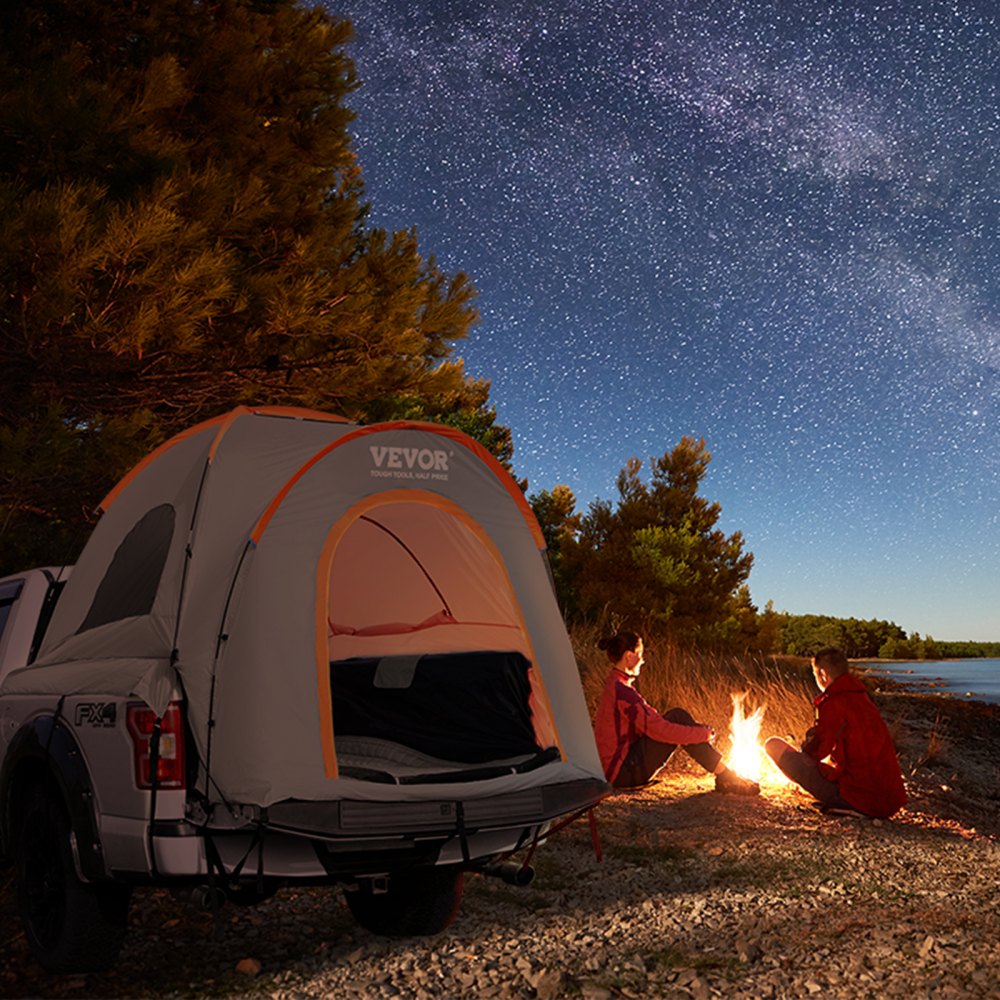 VEVOR truck bed tent by a campfire under a starry night, set up on a truck.