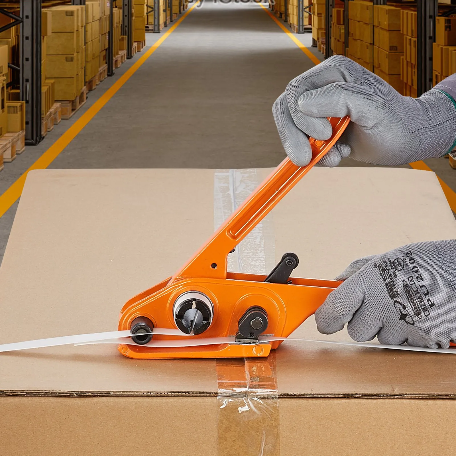 warehouse worker using VEVOR banding strapping kit to secure a cardboard box with plastic strap.