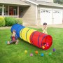 kids playing with VEVOR kids play tunnel in a colorful backyard, surrounded by scattered balls.