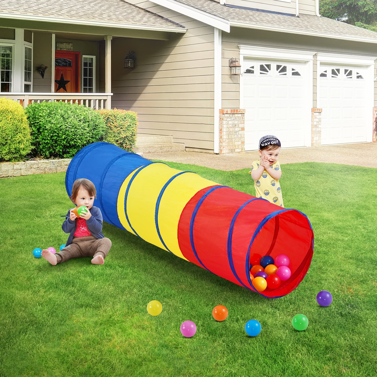 kids playing with VEVOR kids play tunnel in a colorful backyard, surrounded by scattered balls.