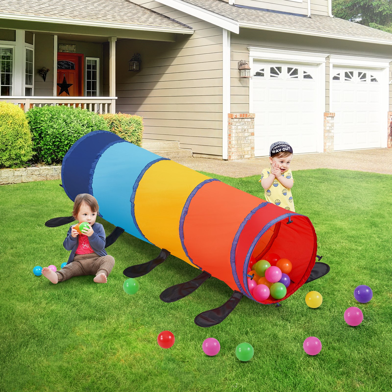 children playing with colorful VEVOR kids play tunnel on a lawn, surrounded by scattered plastic balls.