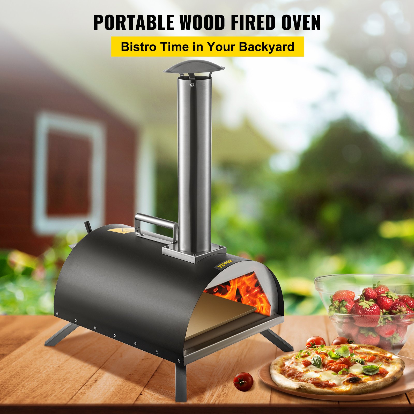 VEVOR outdoor pizza oven in backyard with a fresh pizza and strawberries nearby.