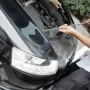 person using VEVOR dent removal kit on black car hood with open engine bay.