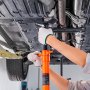 mechanic using VEVOR underhoist support stand to secure vehicle&#039;s undercarriage in a repair shop.
