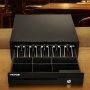 VEVOR cash register drawer on a wooden counter with empty compartments and an open drawer.