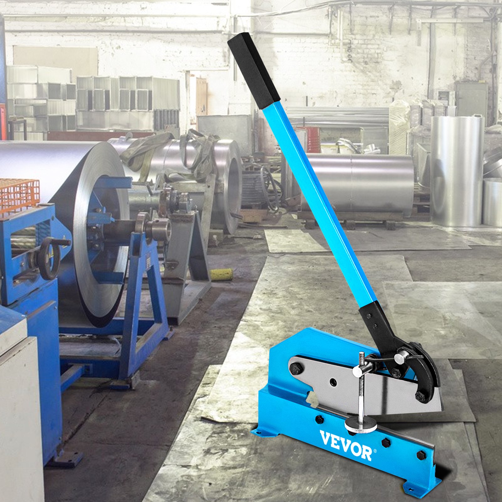 VEVOR hand plate shear in a workshop with metal rolls in the background.