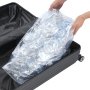 packing a VEVOR inflatable bumper ball into a black suitcase for easy transport.