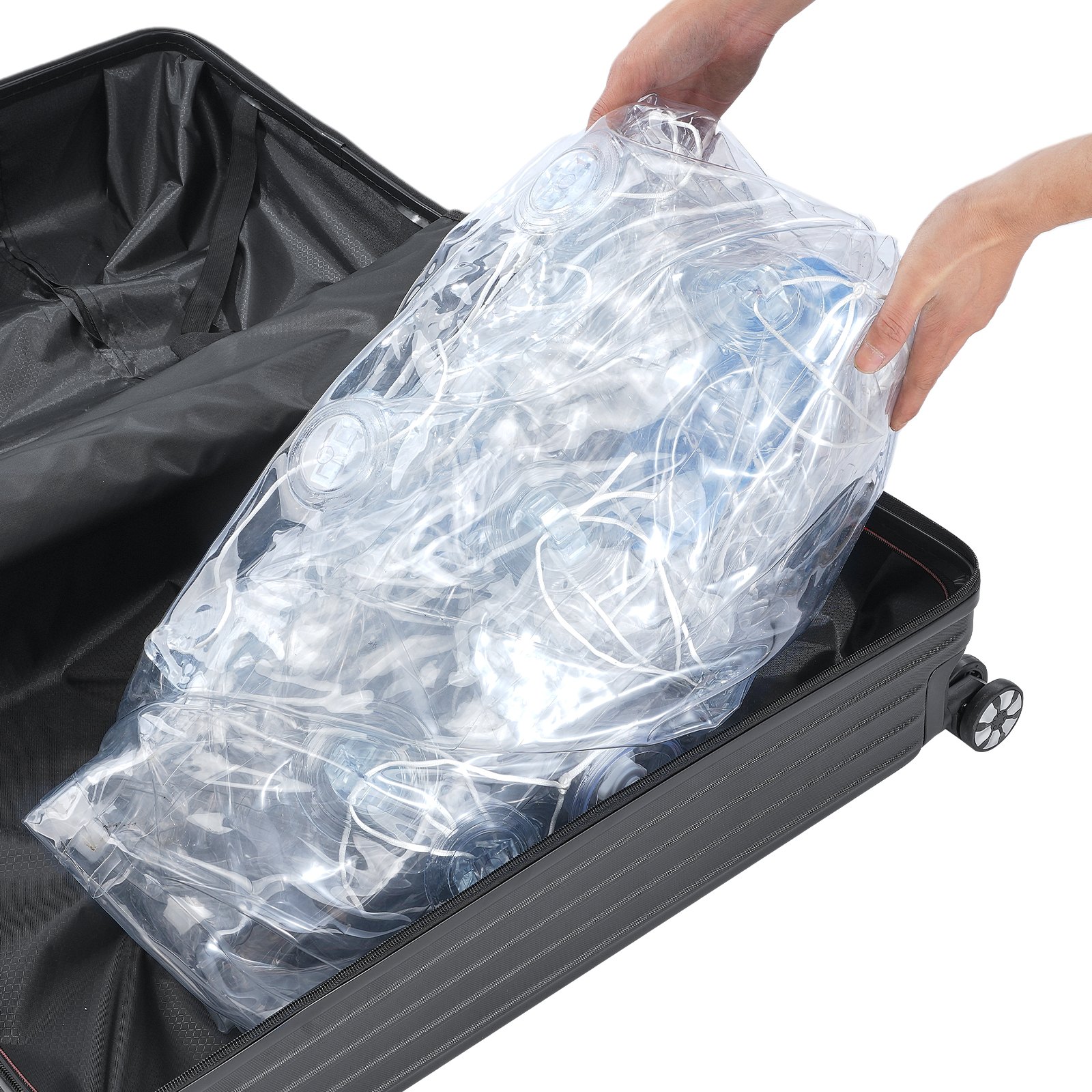 packing a VEVOR inflatable bumper ball into a black suitcase for easy transport.