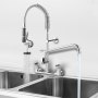VEVOR commercial faucet with spring pull-down sprayer and dual sinks in a stainless steel setup.