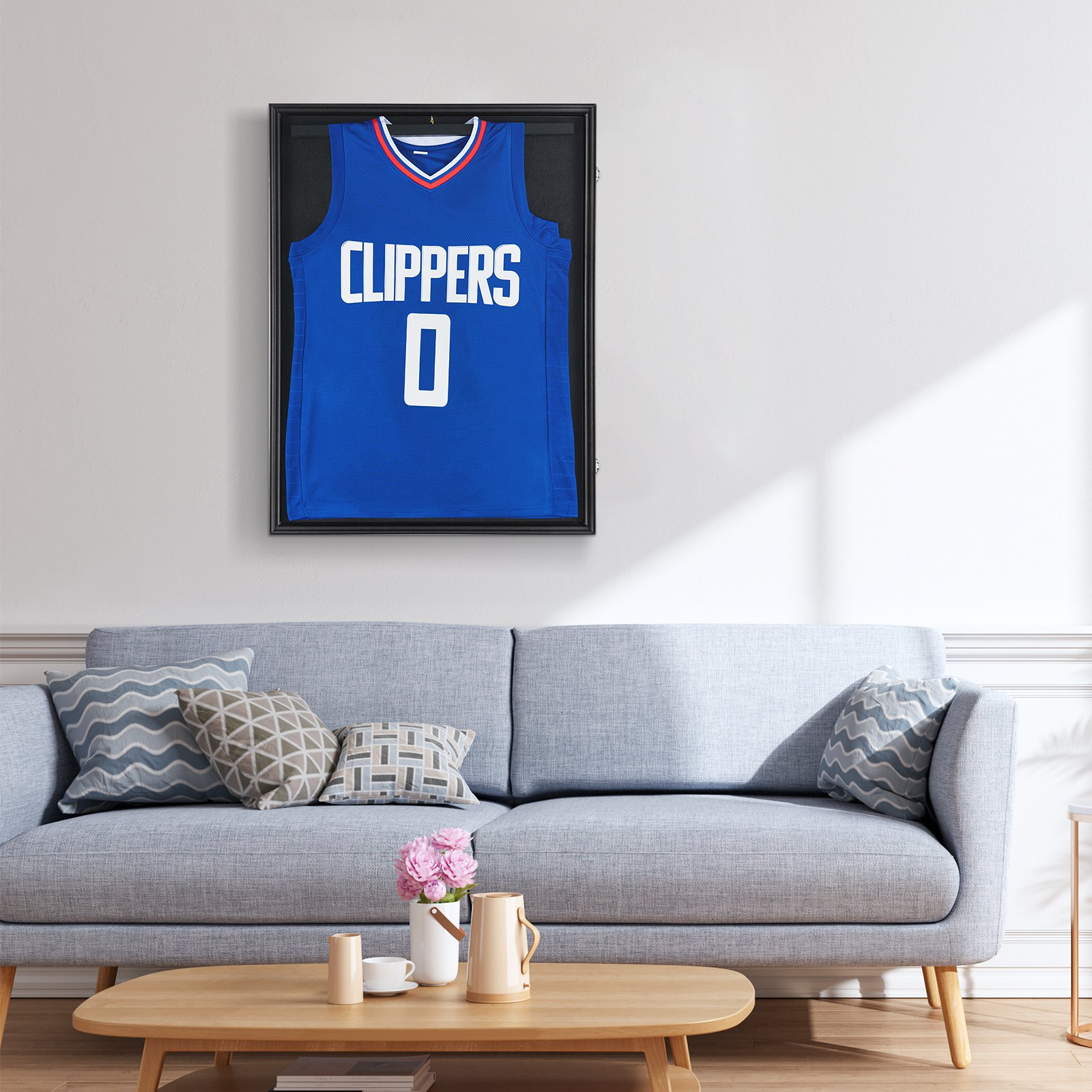 blue clippers jersey in a VEVOR jersey display frame above a light gray sofa and wooden coffee table.