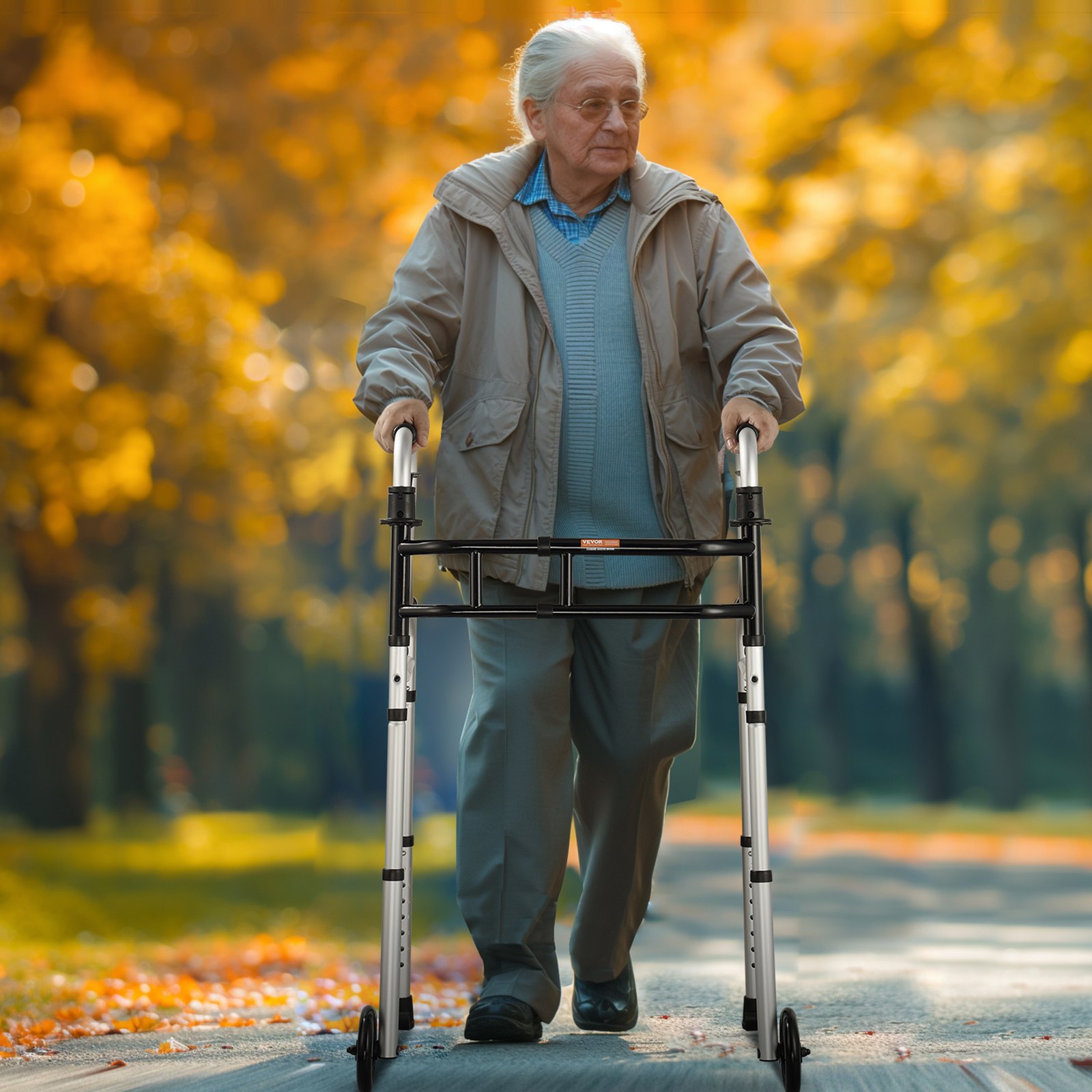 senior using VEVOR folding walker in a park with autumn foliage in the background.