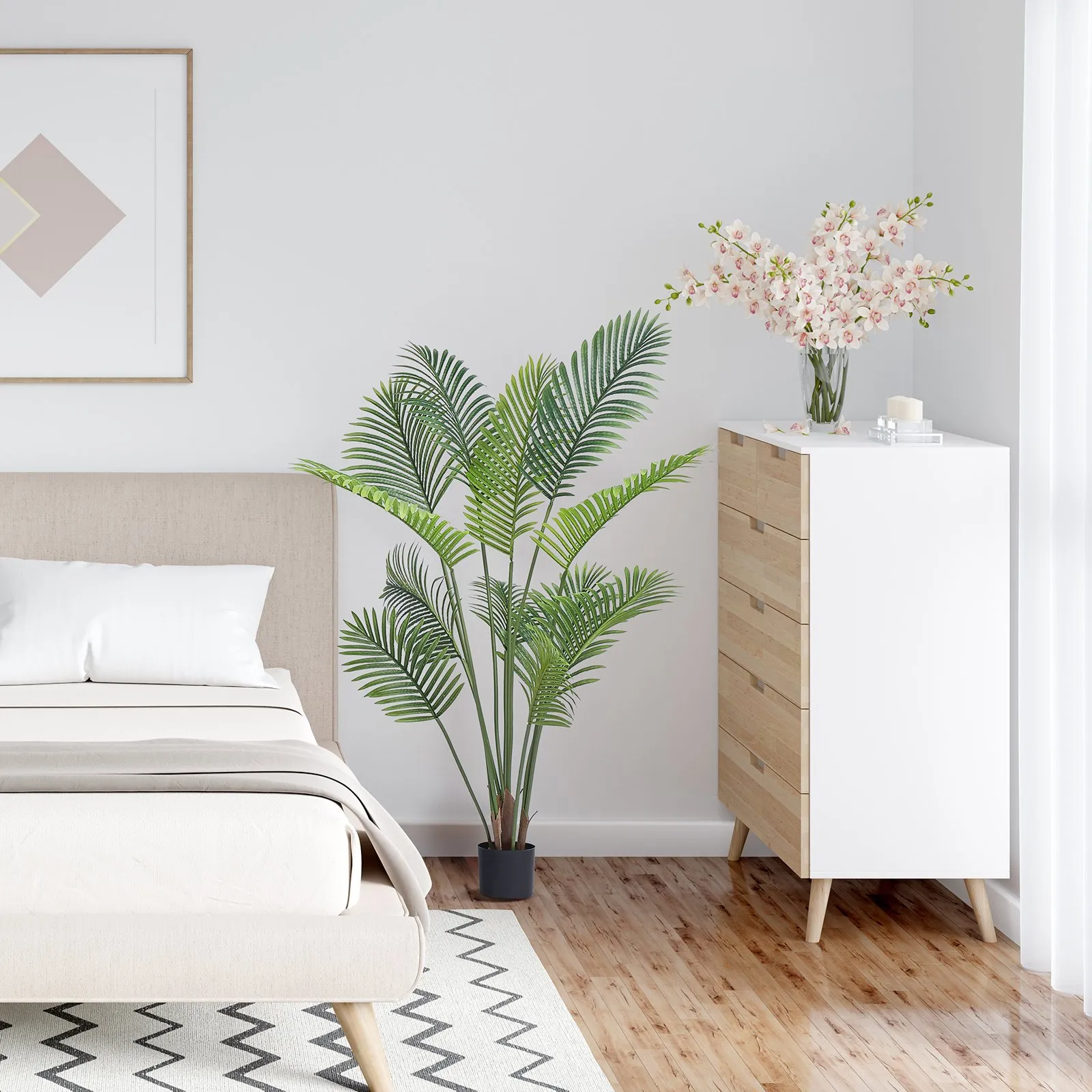 bedside setup with VEVOR artificial palm tree, white dresser, pink flowers on top, and geometric wall art.