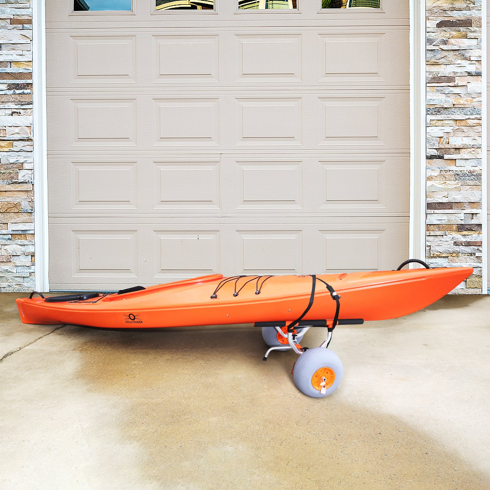 orange kayak on VEVOR heavy duty kayak cart with gray wheels, parked in front of a garage door.