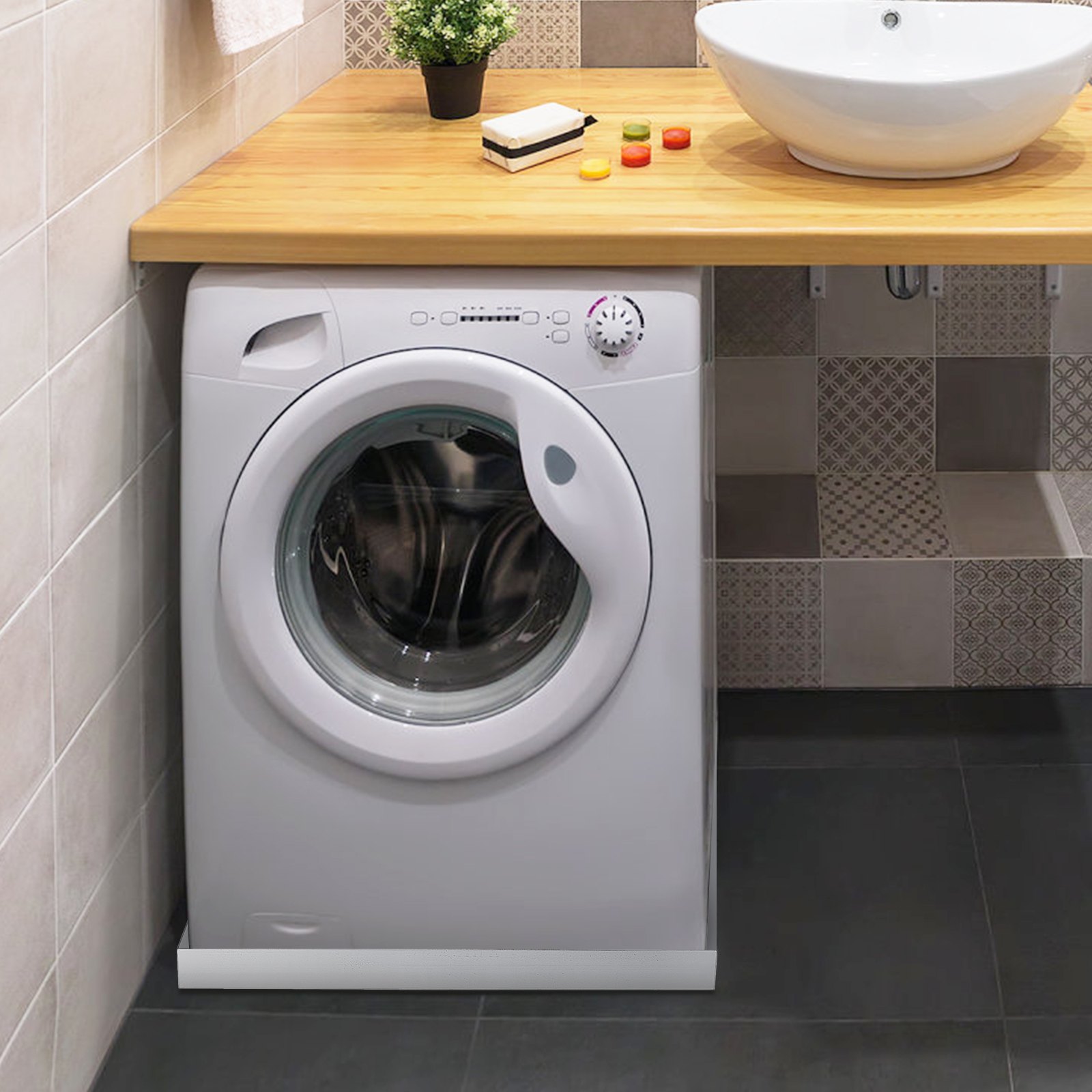 white washing machine under wooden countertop with sink, plant, soap, and VEVOR washing machine pan.