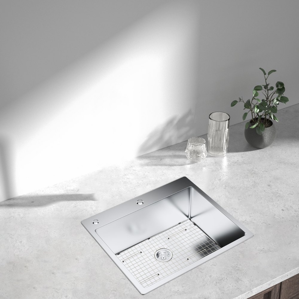modern kitchen sink with VEVOR sink protector grid, glasses, and a small plant on the counter.