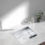 modern kitchen sink with VEVOR sink protector grid, glasses, and a small plant on the counter.